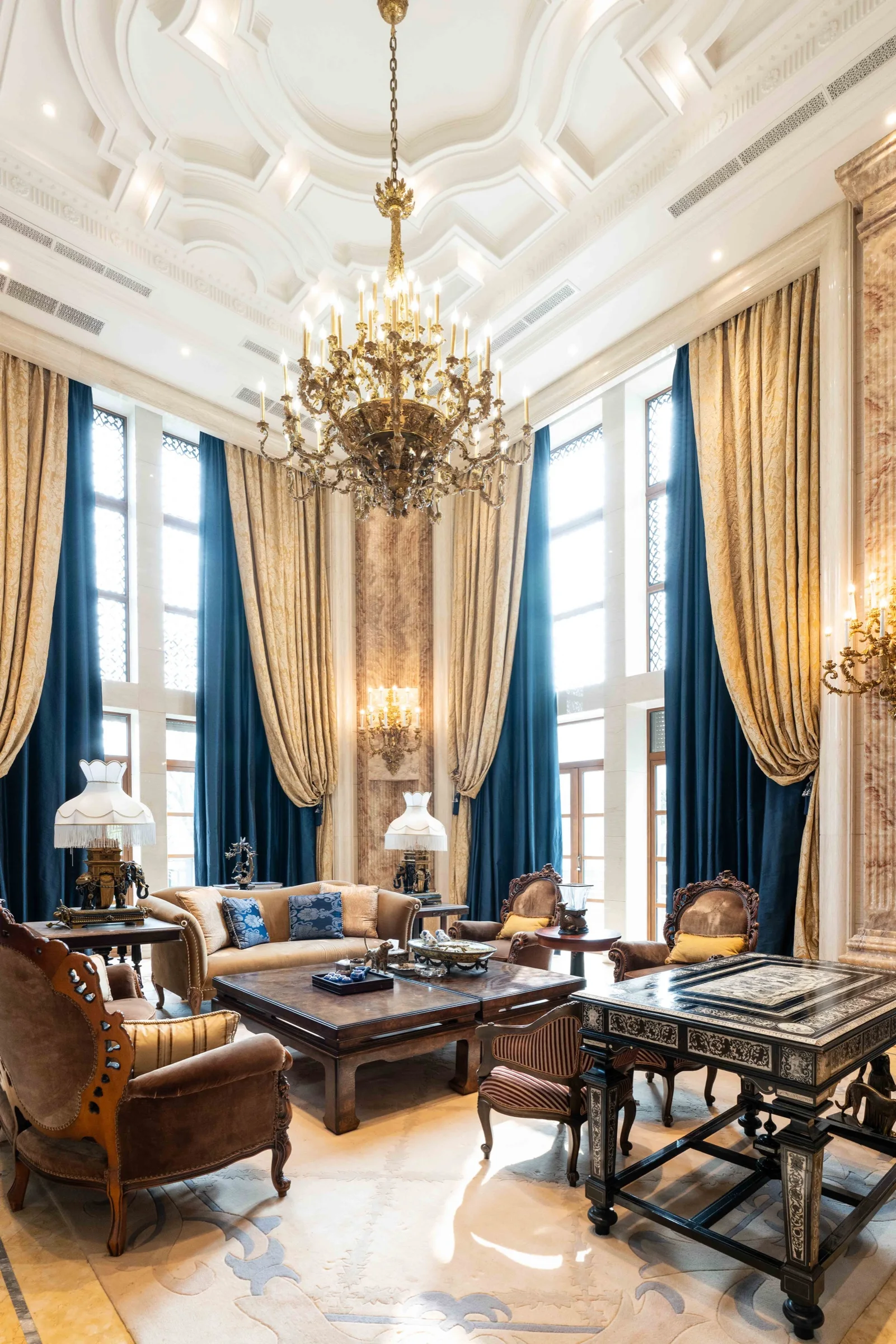 A grand private villa salon with a sculptural chandelier