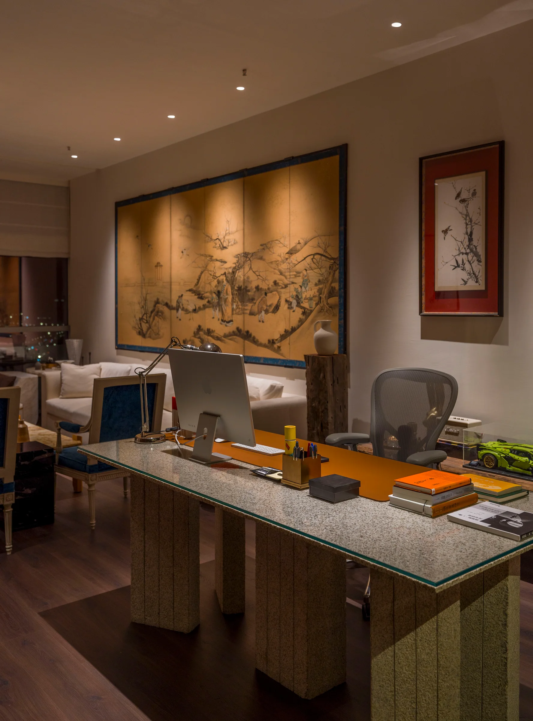 A private office with Chinese art and a sculptural desk